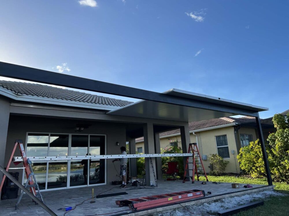 screen roof builder installing roof panels in Sun City Center FL